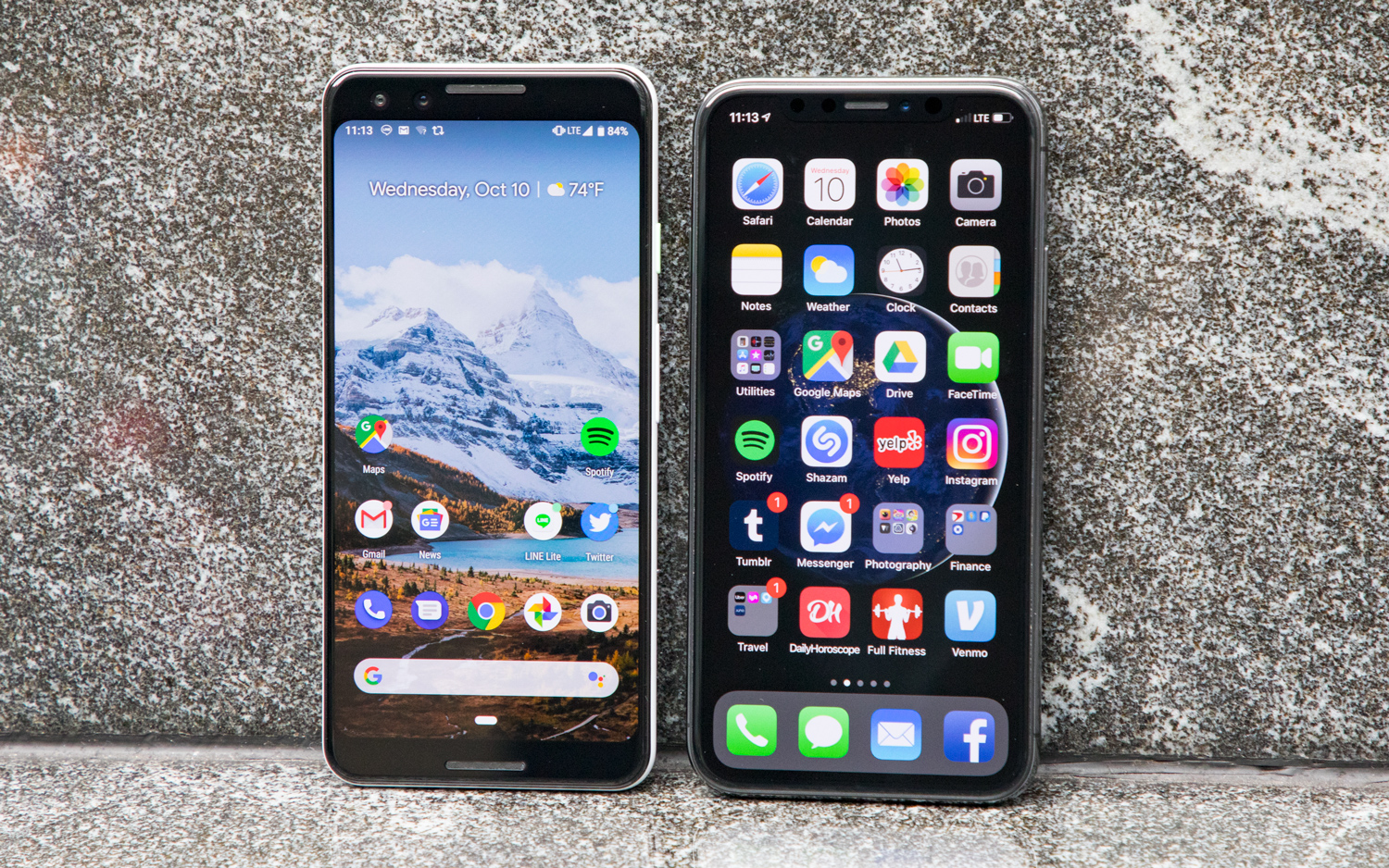 Two attractive smartphones displayed side by side,
                        upright on a granite background.